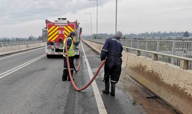Municipalidad de Colbún y Bomberos limpian puente sobre el río Maule